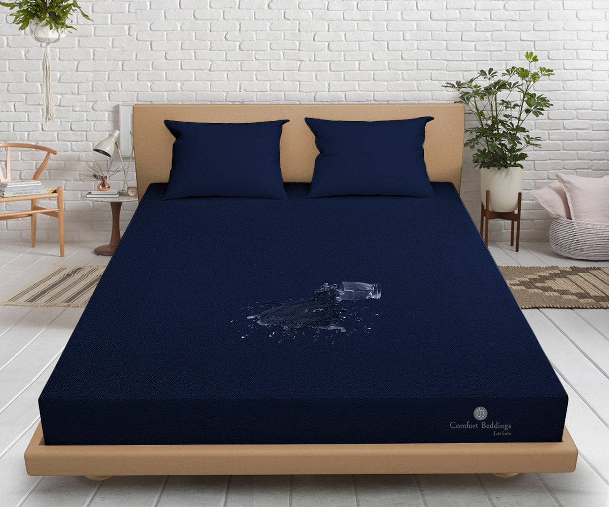 Navy blue waterproof terry mattress protector fitted on a bed