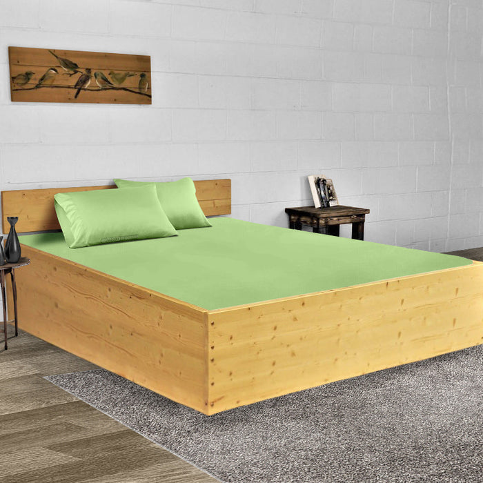 Fresh clean cotton bed sheets on a made bed
