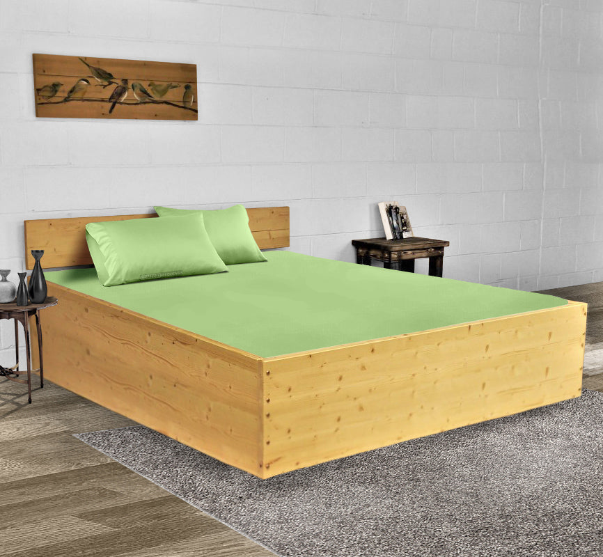 Fresh clean cotton bed sheets on a made bed