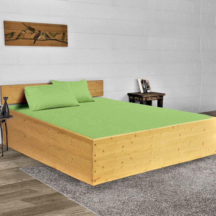 Sage stripe waterbed sheet set on a made waterbed
