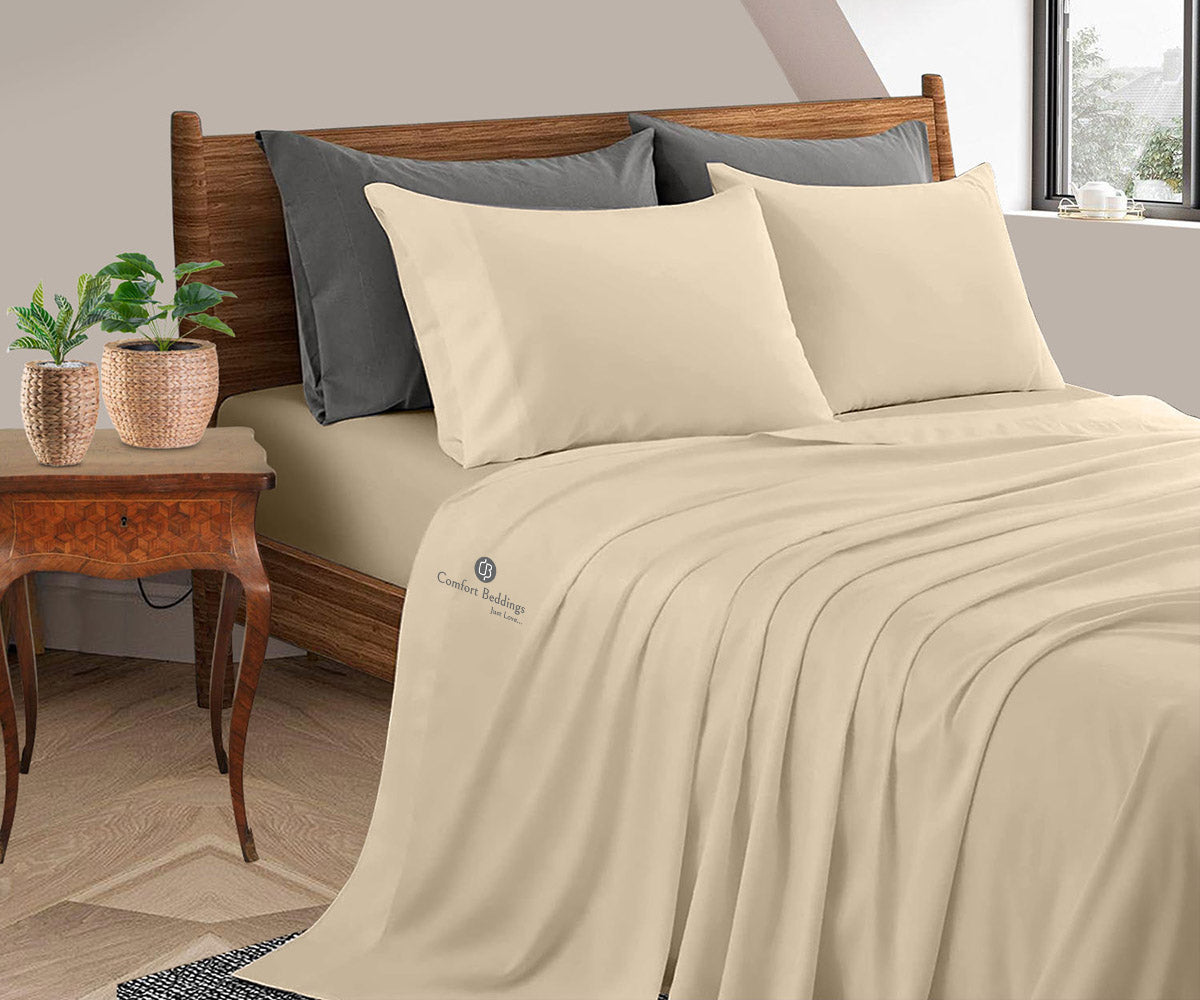 Sand-colored bamboo sheet set on a made bed